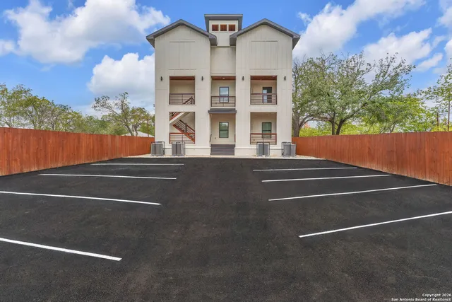 a view of a tall building next to a yard