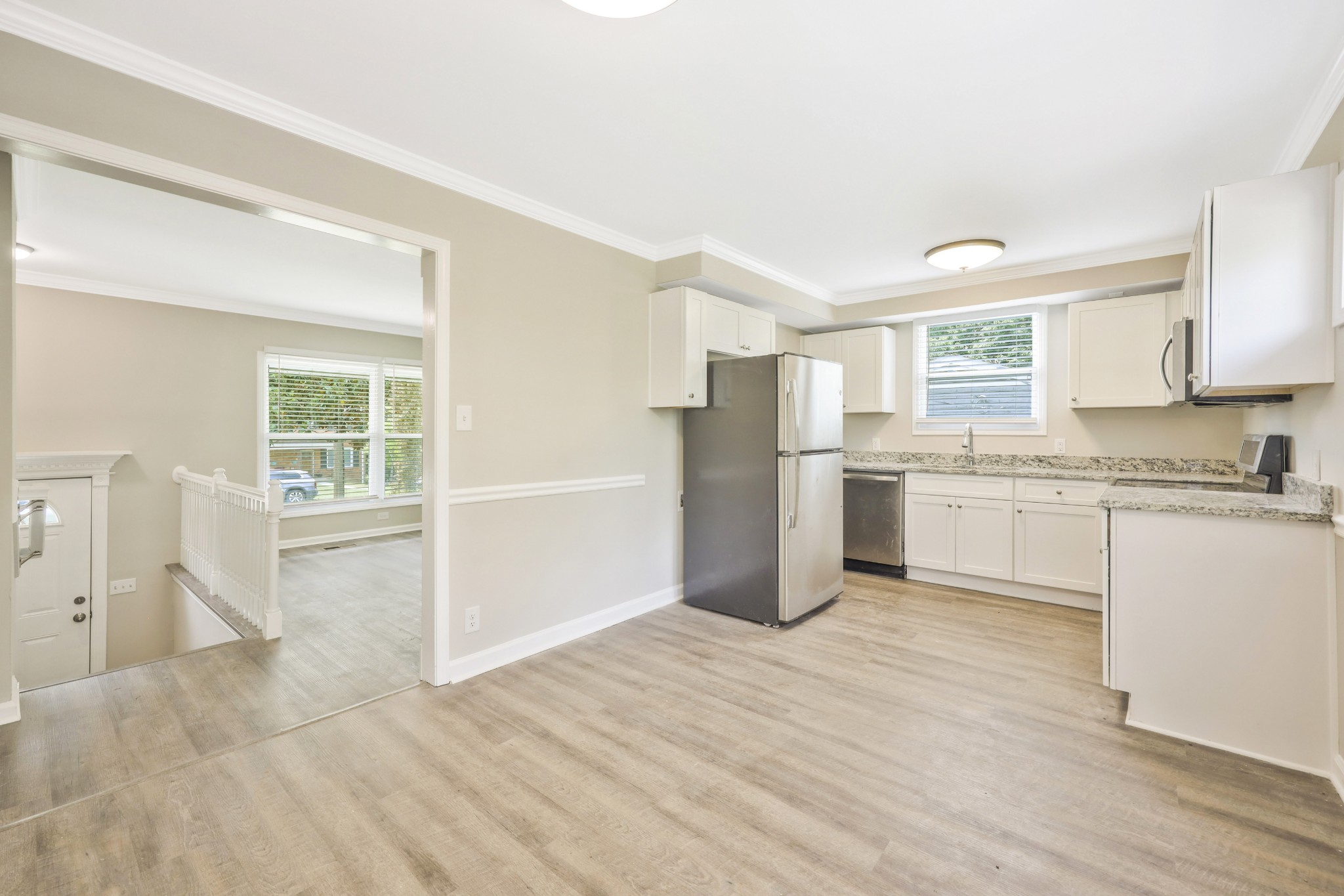 318 Bonnahurst Drive Hermitage, TN 37076 - Photo 6 of 30 a kitchen with a refrigerator and white cabinets