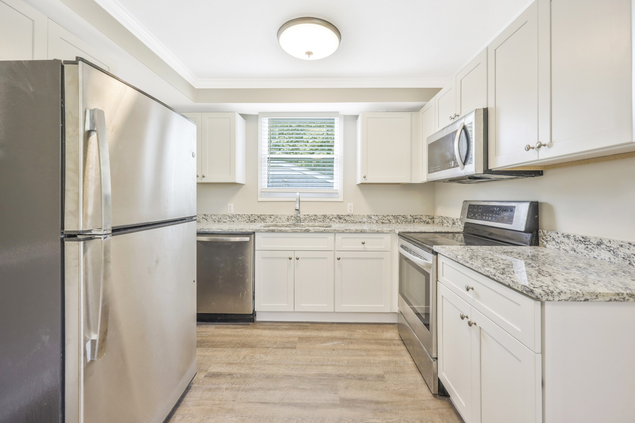 318 Bonnahurst Drive Hermitage, TN 37076 - Photo 7 of 30 a kitchen with white cabinets and white appliances