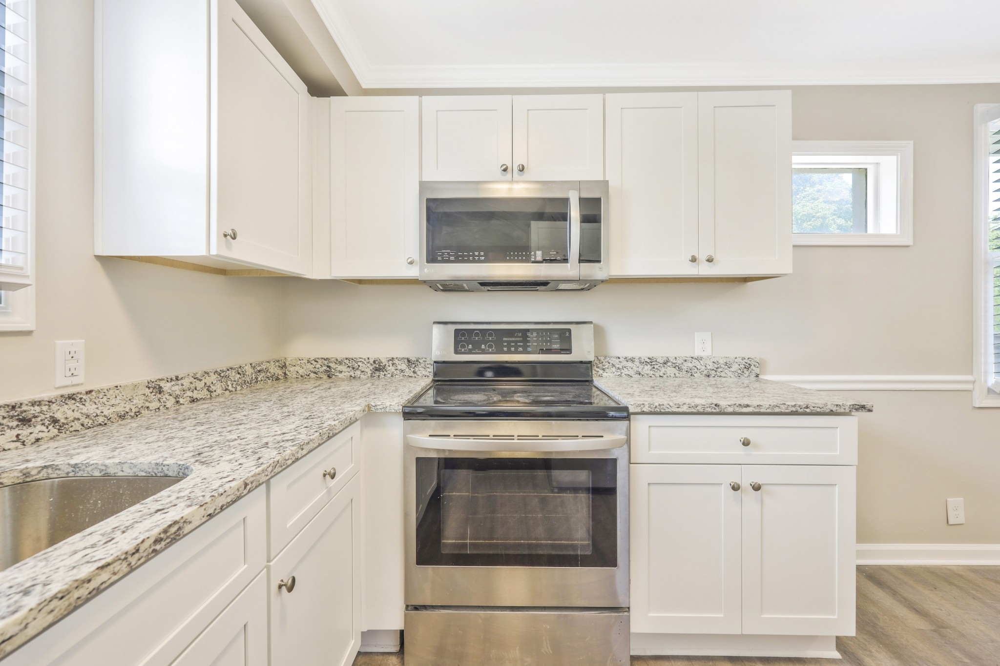 318 Bonnahurst Drive Hermitage, TN 37076 - Photo 8 of 30 a kitchen with granite countertop white cabinets and white appliances