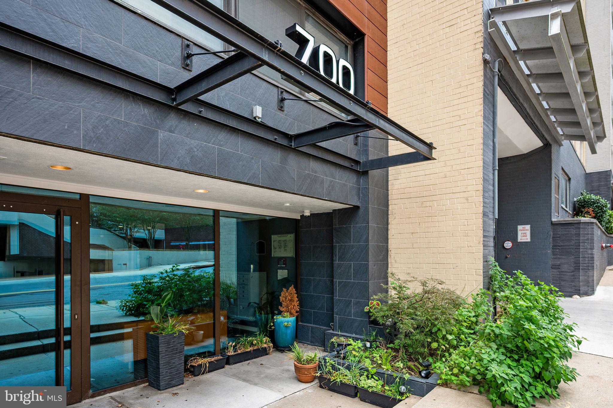 700 Roeder Road, Unit 203 Silver Spring, MD 20910 - Photo 30 of 37 Modern entrance with lush greenery.
