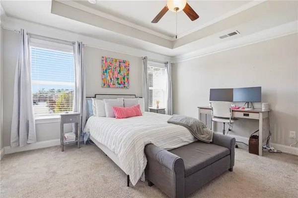 a bedroom with a bed couch and a window