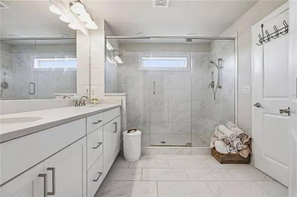 a bathroom with a sink a toilet and shower
