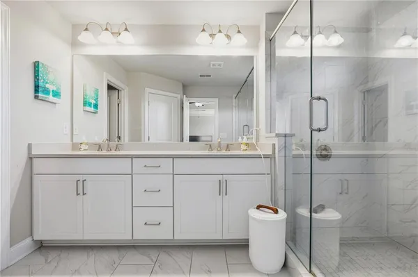 a bathroom with a granite countertop sink a toilet and a mirror