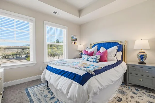a bed sitting in a bedroom next to a window