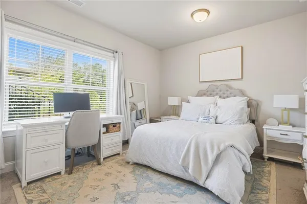 a bedroom with a bed and a window
