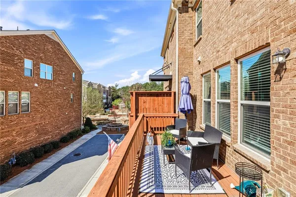 a view of balcony with chairs and wooden fence