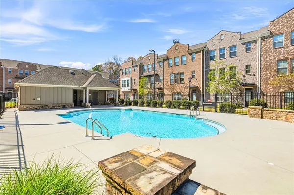 a swimming pool with buildings in the background