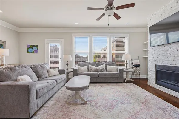a living room with furniture a flat screen tv and a fireplace
