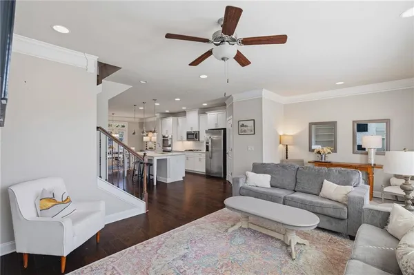 a living room with furniture and kitchen view
