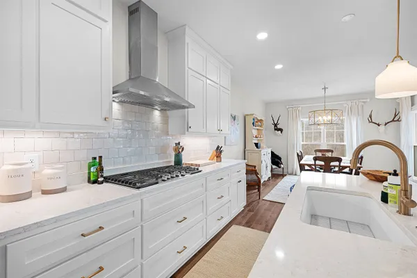 a kitchen with kitchen island granite countertop a sink stainless steel appliances and cabinets