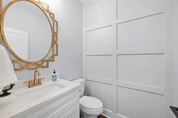a bathroom with a sink a toilet and a mirror