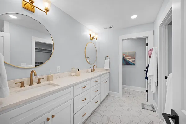 a bathroom with a double vanity sink mirror and shower