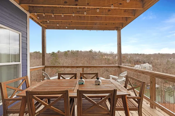 a view of a balcony with table and chairs