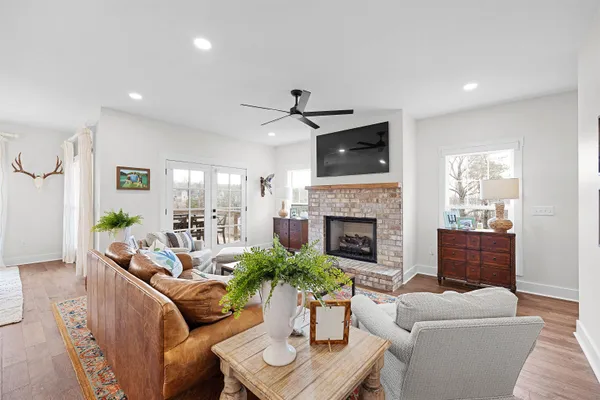 a living room with furniture a fireplace and a potted plant