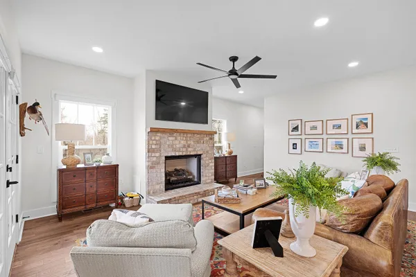 a living room with furniture a fireplace and a flat screen tv