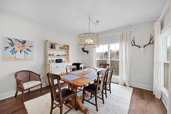 a view of a dining room with furniture wooden floor and a chandelier