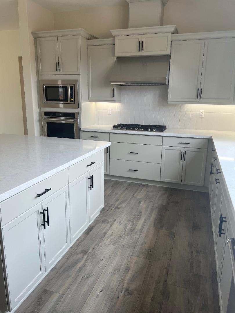 480 Lassen Way Marina, CA 93933 - Photo 13 of 19 a kitchen with granite countertop white cabinets and stainless steel appliances