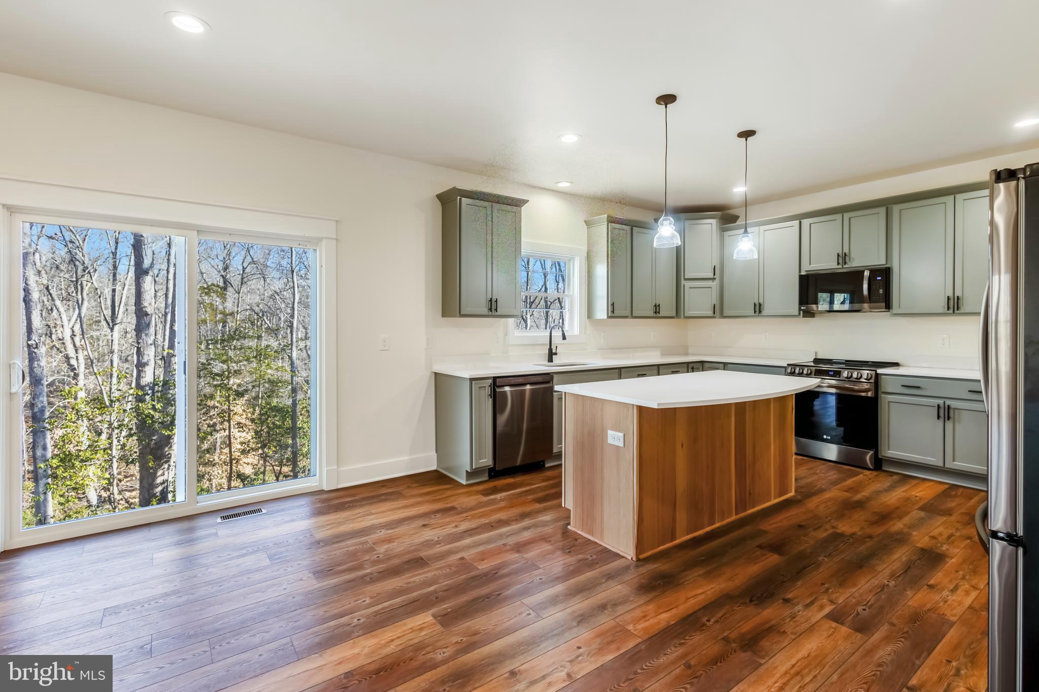 2 Windsor Drive King George, VA 22485 - Photo 15 of 60 a large kitchen with stainless steel appliances granite countertop a stove a sink and a refrigerator
