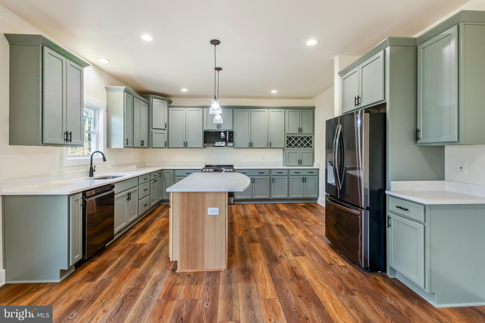 2 Windsor Drive King George, VA 22485 - Photo 17 of 60 a large kitchen with stainless steel appliances granite countertop a refrigerator a oven a stove and a wooden floors