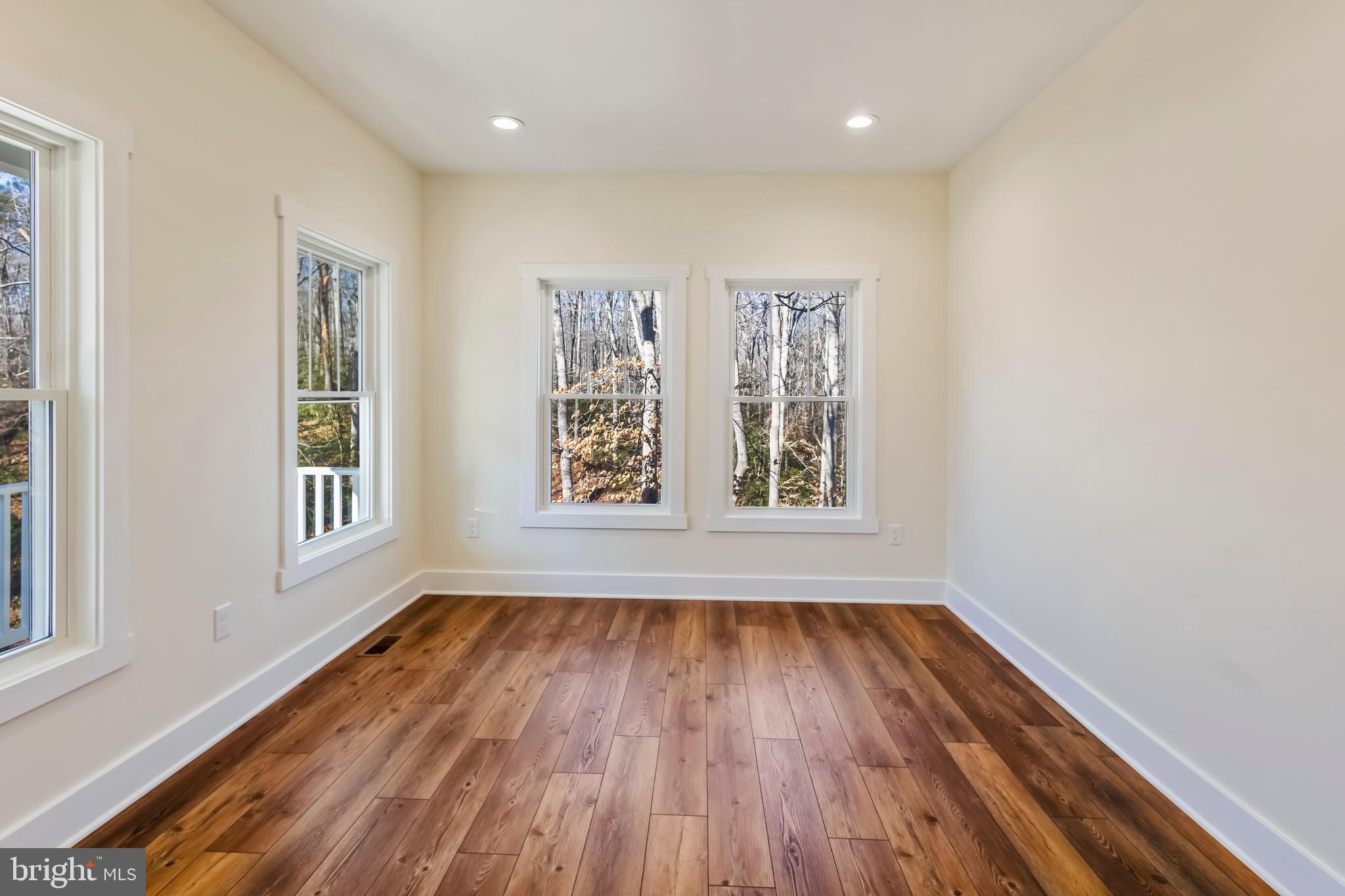 2 Windsor Drive King George, VA 22485 - Photo 18 of 60 a view of an empty room with wooden floor and a window