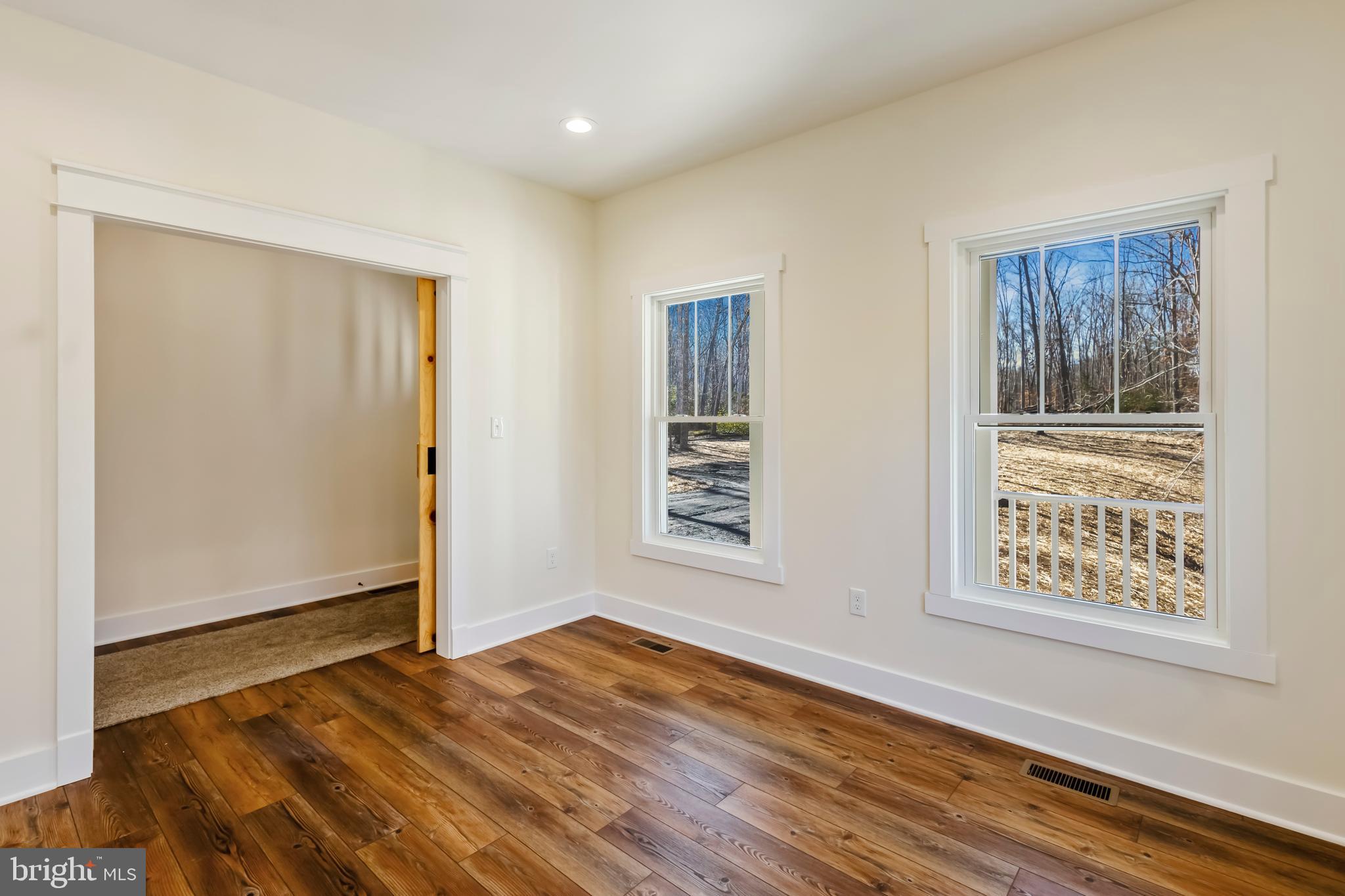2 Windsor Drive King George, VA 22485 - Photo 19 of 60 a view of an empty room with wooden floor and a window
