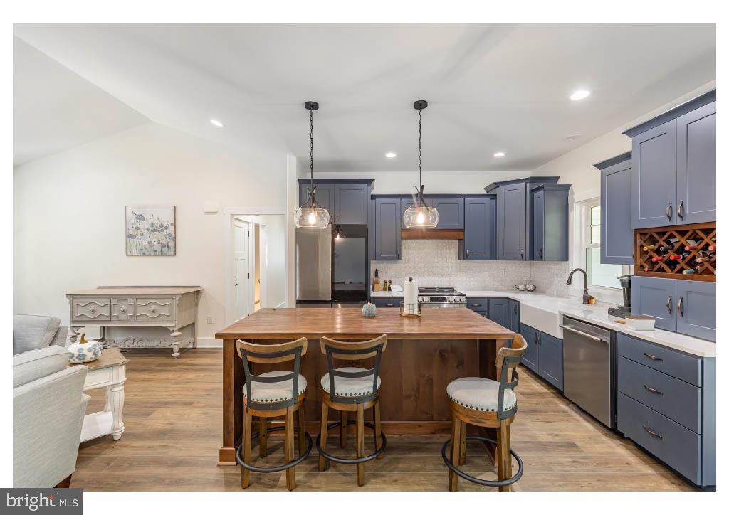 2 Windsor Drive King George, VA 22485 - Photo 42 of 60 a kitchen with a table chairs refrigerator and cabinets