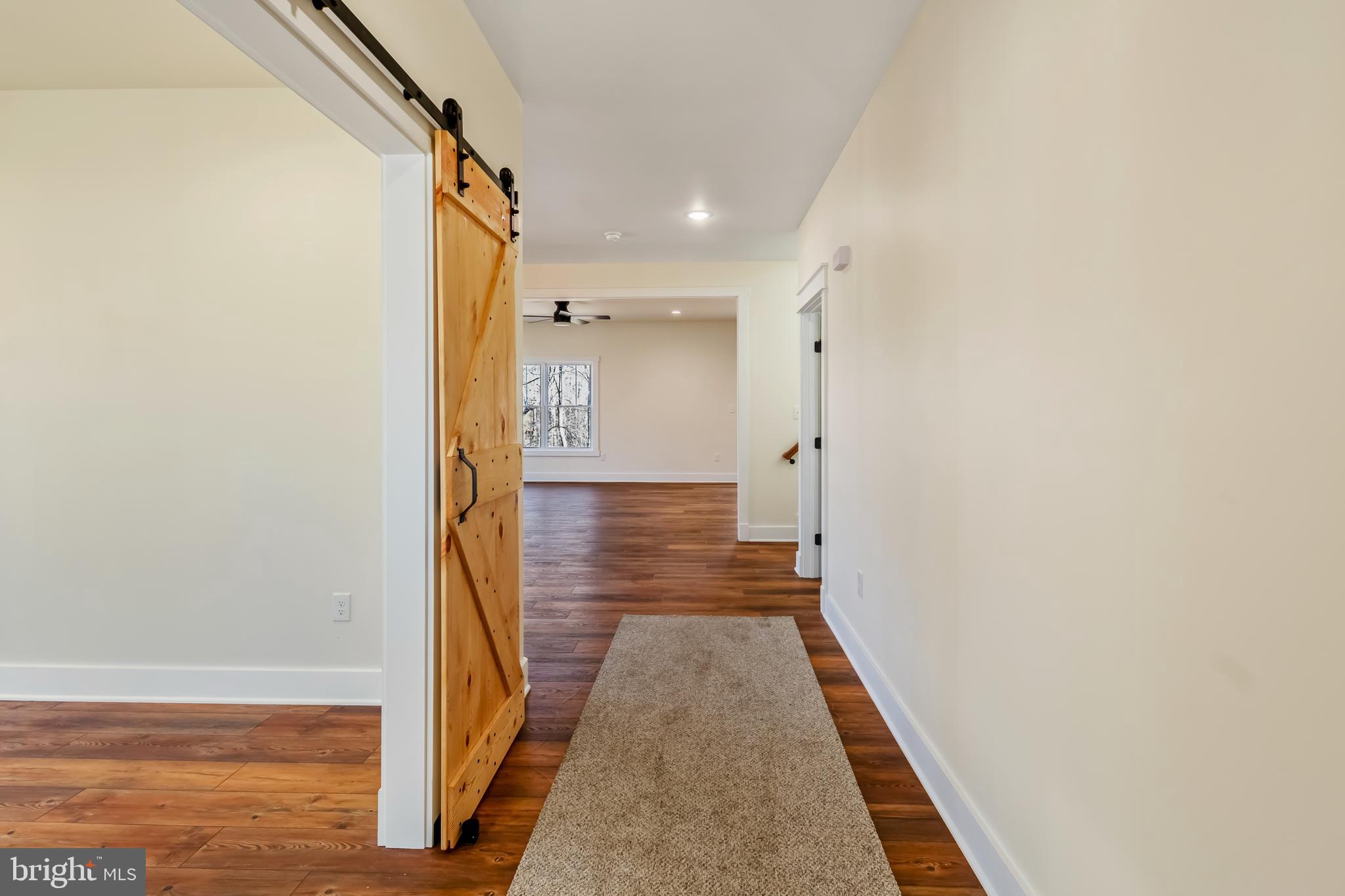 2 Windsor Drive King George, VA 22485 - Photo 7 of 60 a view of a hallway with wooden floor and staircase