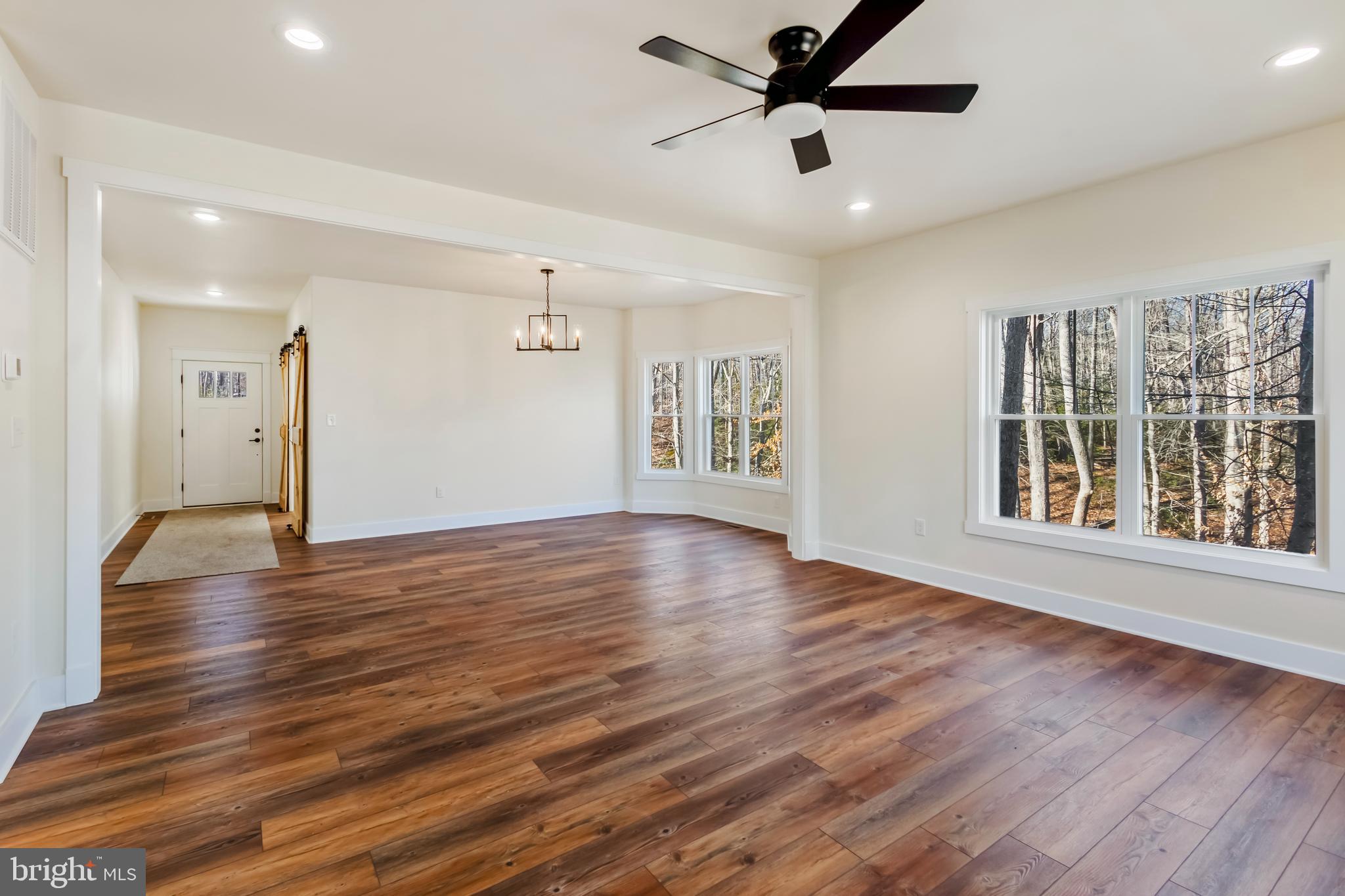 2 Windsor Drive King George, VA 22485 - Photo 9 of 60 a view of an empty room with wooden floor and a window
