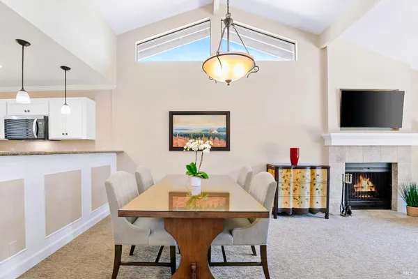 a view of a dining room with furniture and a fireplace