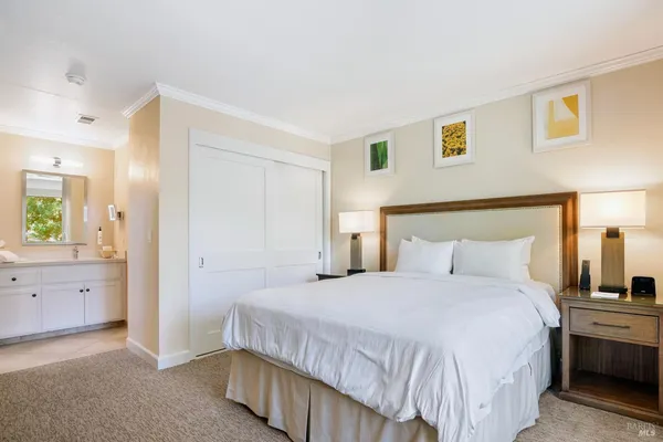 a bedroom with a bed and a television