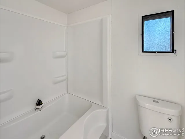 a bathroom with a bathtub and toilet