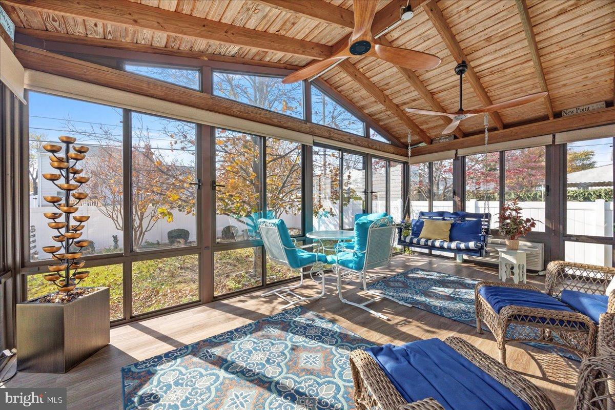 Sunlit sunroom with vibrant decor and views.