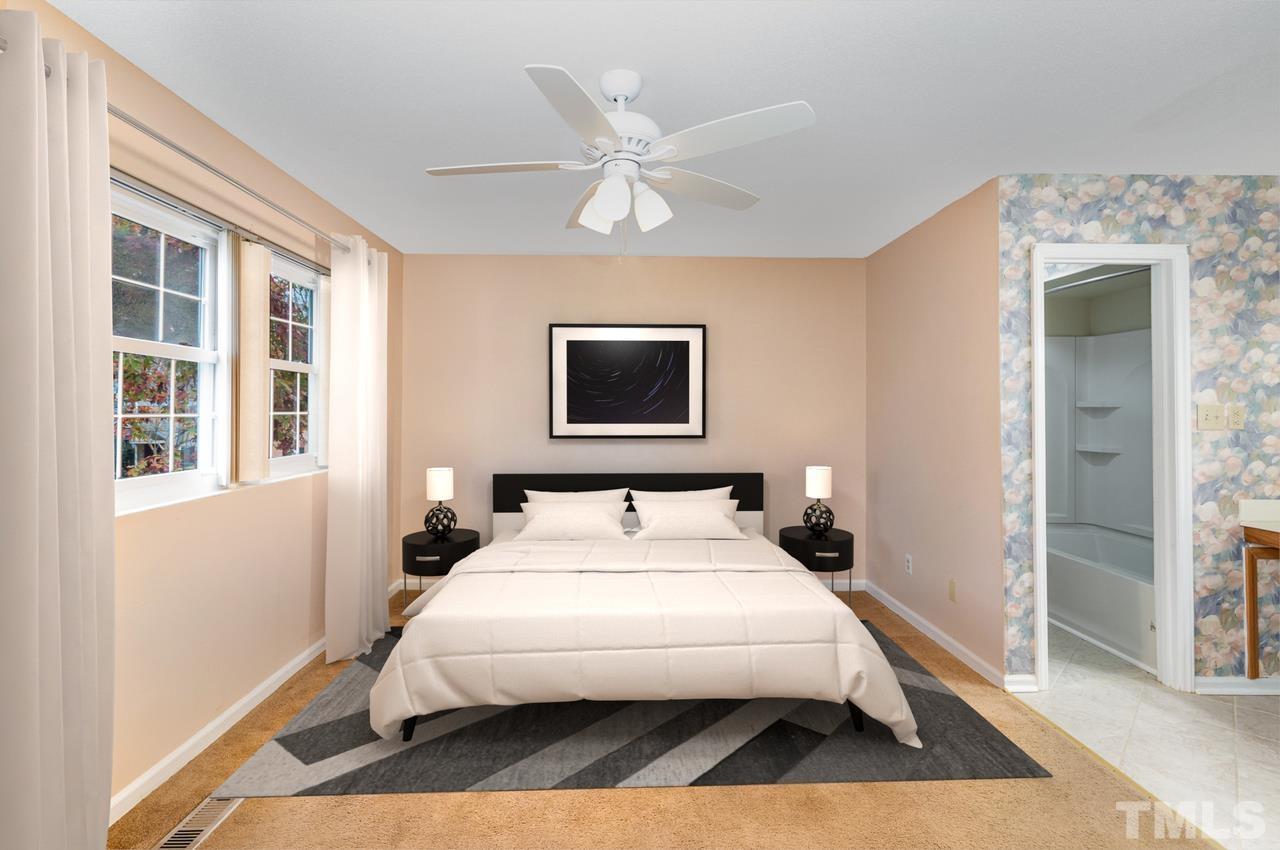 6553 New Market Way, Unit 6553 Raleigh, NC 27615 - Photo 26 of 27 Spacious primary bedroom with enough space for a king size bed. Primary bedroom has private full bathroom. Virtually Staged