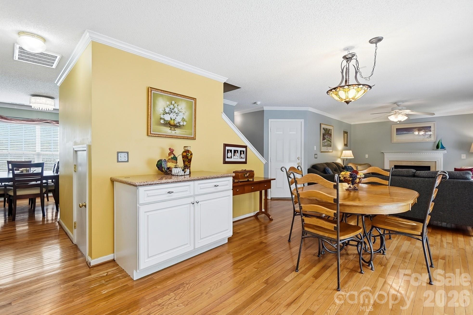 442 Sugar Maple Drive Tega Cay, SC 29708 - Photo 13 of 48 a view of a dining room with furniture a chandelier and wooden floor