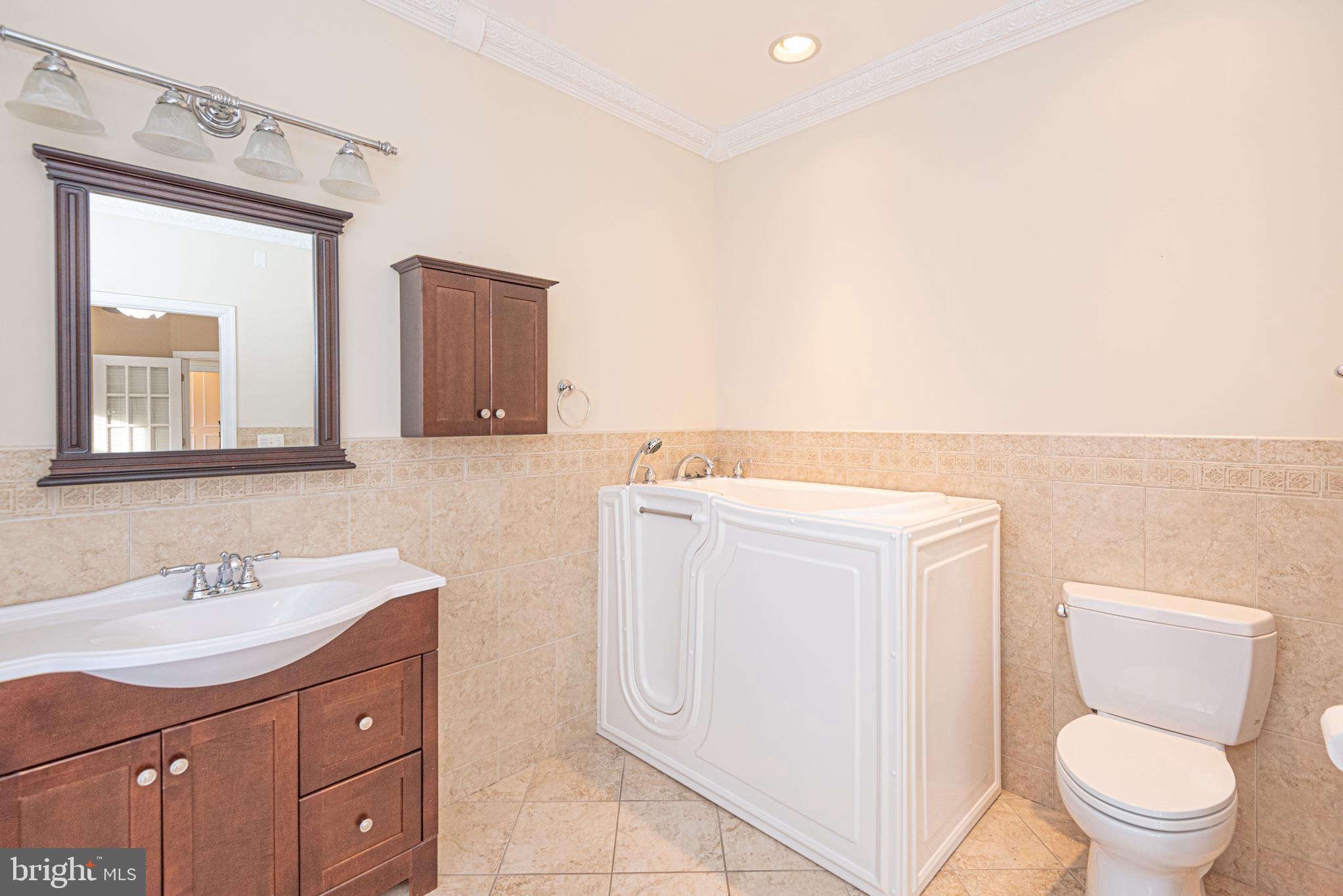 12004 Turtle Mill Road Bishopville, MD 21813 - Photo 19 of 69 a bathroom with a toilet sink and mirror