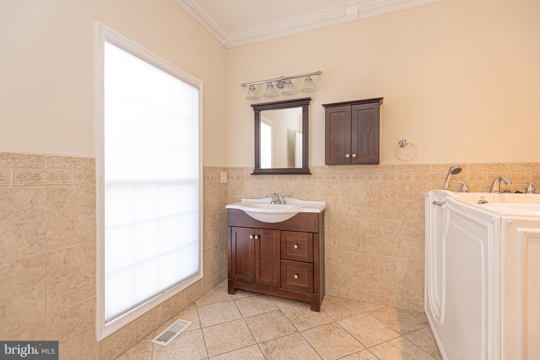 12004 Turtle Mill Road Bishopville, MD 21813 - Photo 21 of 69 a bathroom with a sink a vanity and a mirror