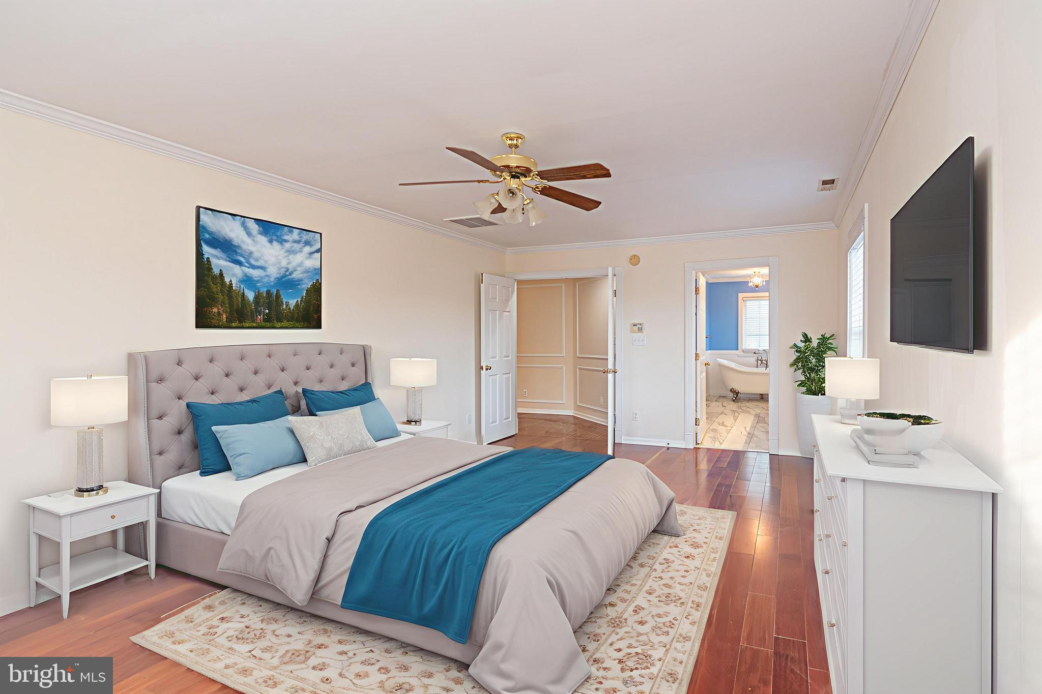 12004 Turtle Mill Road Bishopville, MD 21813 - Photo 42 of 69 a bedroom with a large bed a flat tv screen and a chandelier