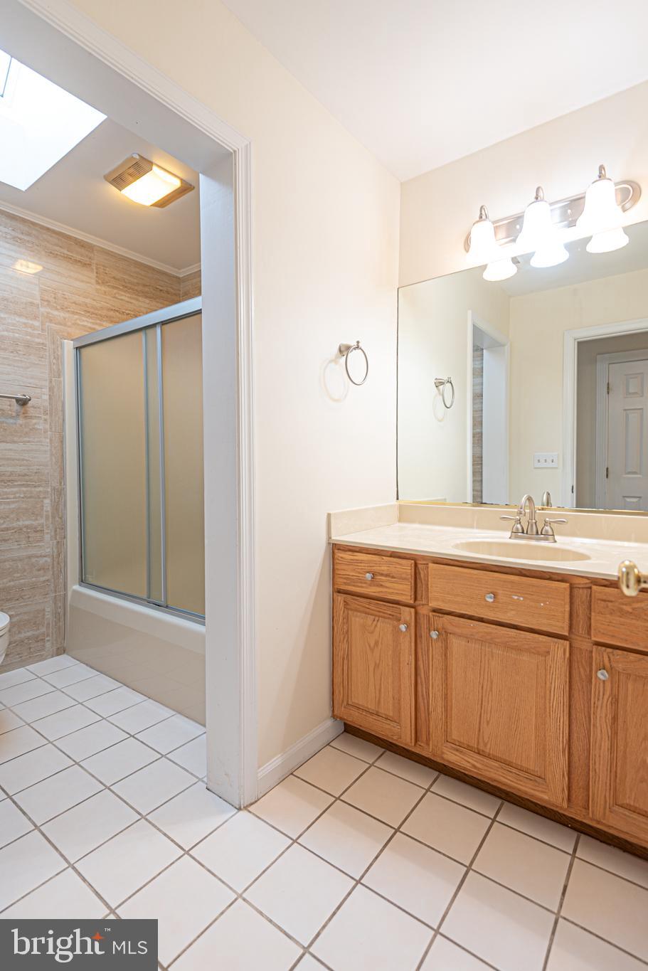 12004 Turtle Mill Road Bishopville, MD 21813 - Photo 58 of 69 a spacious bathroom with a mirror sink and a mirror