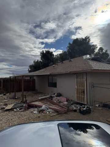 a view of a house with backyard tub and a sink