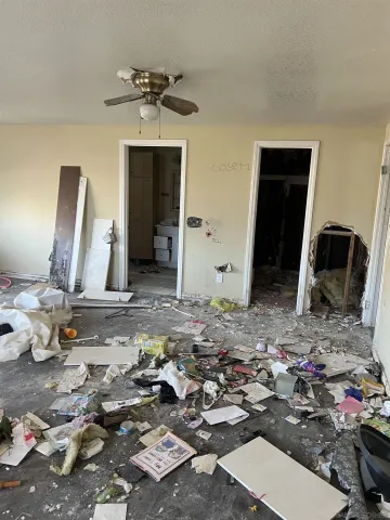 a view of a bedroom with a bed and mirror