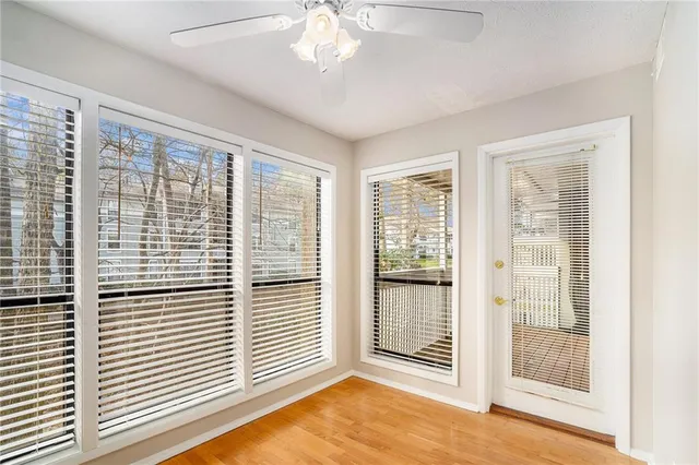 a view of a livingroom with a ceiling fan and window
