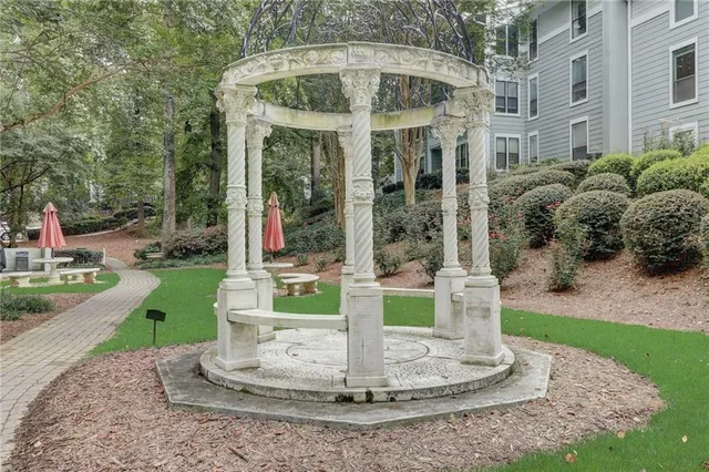 a view of a house with a yard and potted plants