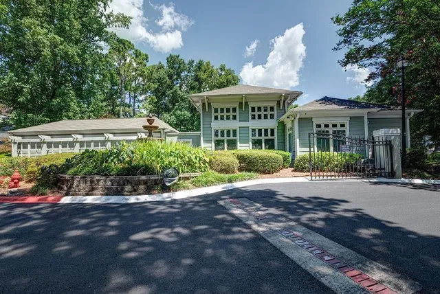 a front view of a house with a yard and potted plants