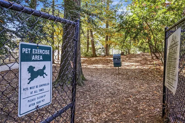 a sign board with tall trees