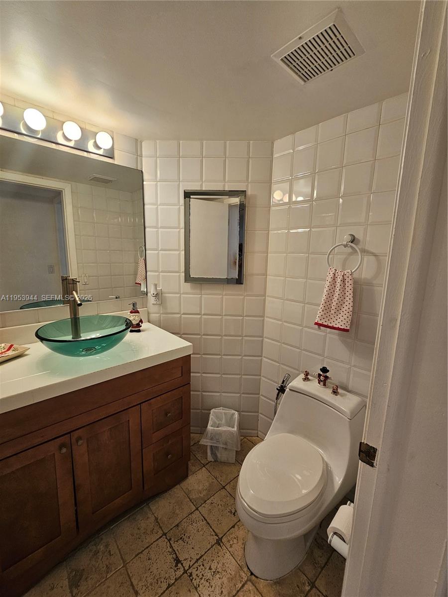 9781 Southwest 138th Avenue, Unit DB1R Miami, FL 33186 - Photo 11 of 16 a bathroom with a toilet sink and mirror