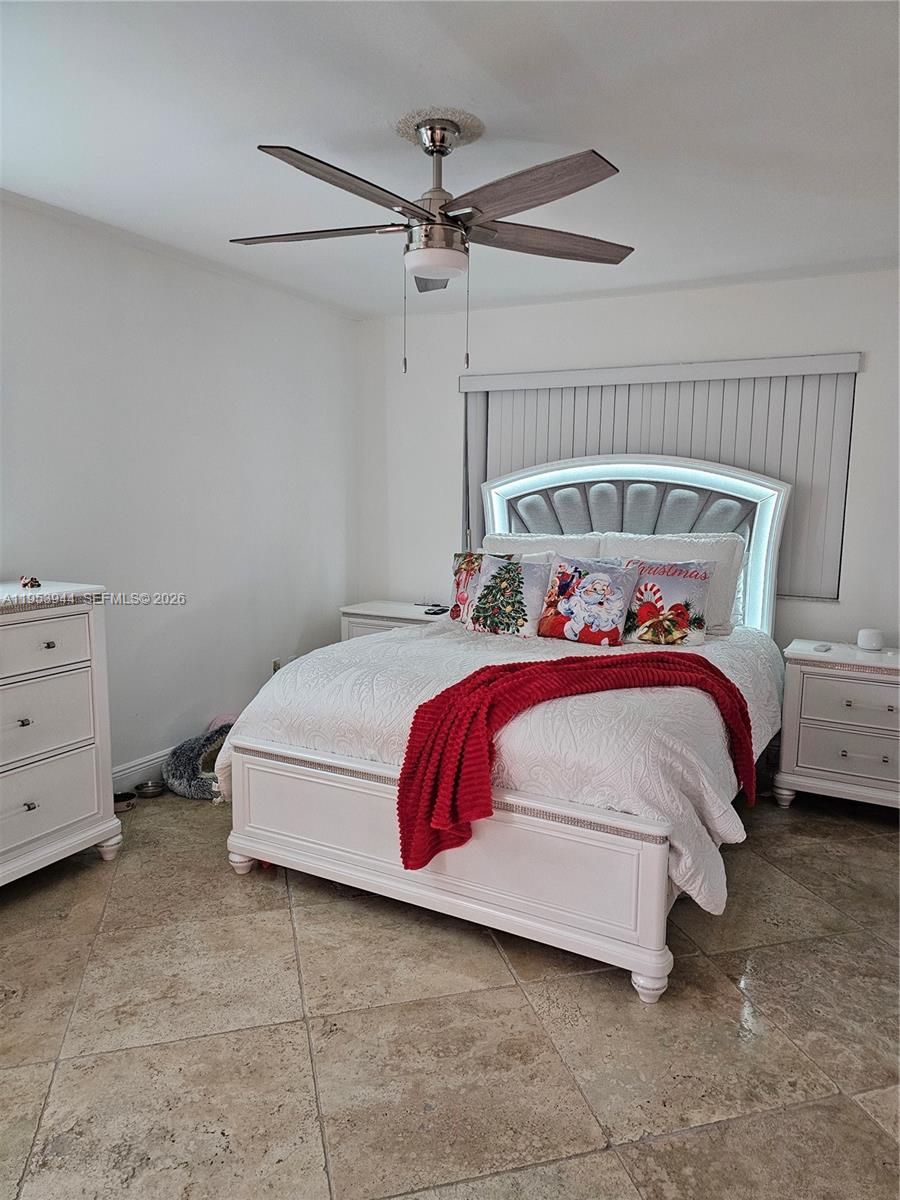 9781 Southwest 138th Avenue, Unit DB1R Miami, FL 33186 - Photo 12 of 16 a bedroom with a bed and a ceiling fan