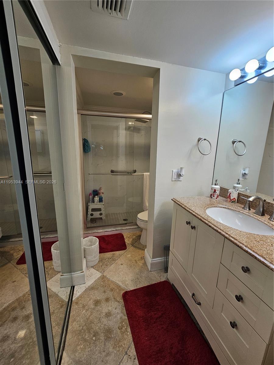 9781 Southwest 138th Avenue, Unit DB1R Miami, FL 33186 - Photo 14 of 16 a spacious bathroom with a double vanity sink a mirror and a shower