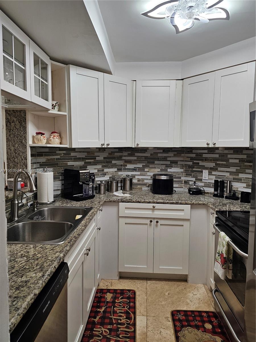9781 Southwest 138th Avenue, Unit DB1R Miami, FL 33186 - Photo 4 of 16 a kitchen with a sink stove and cabinets