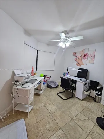 a bedroom with a bed and a ceiling fan